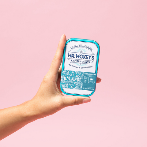 A tin of Mr. Moxey's THC and CBD Balance mints being held 