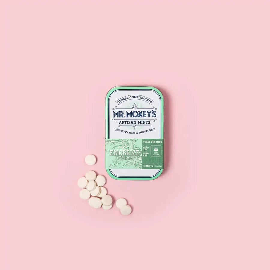 Green Energize tin with 1:1 THC and CBC mints on pink background